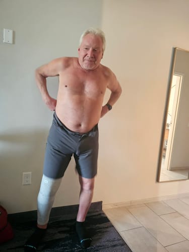 Customer's Premium Bamboo Leg Sleeve on their lower right leg while standing in a room.