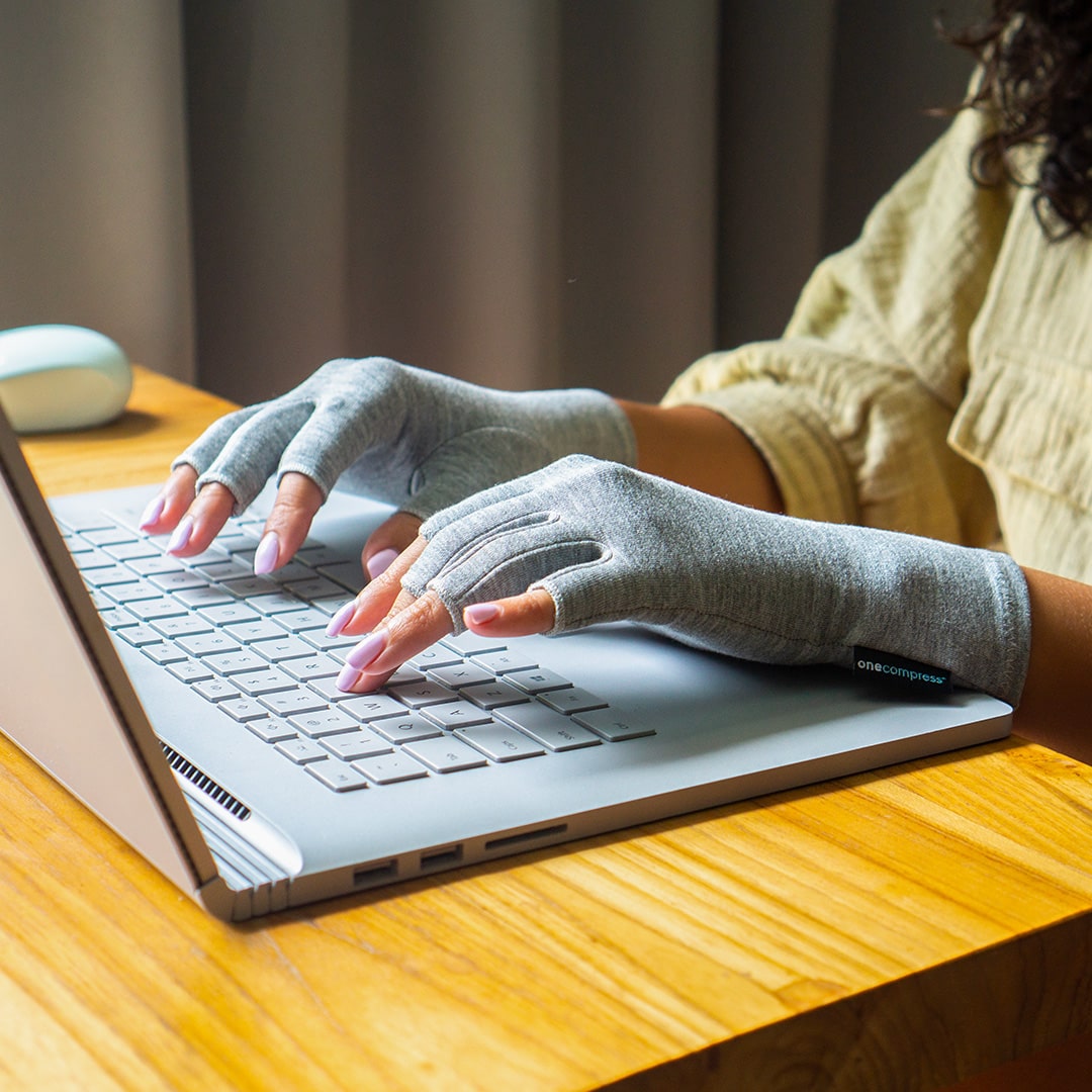 Bamboo compression gloves at a laptop