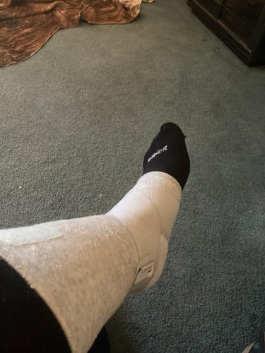 Reviewer wearing the grey Premium Bamboo Ankle Support over a black sock on their ankle.
