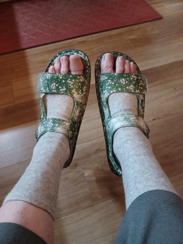 Customer wearing the gray Anti-Fatigue Bamboo Footsleeves with floral sandals.