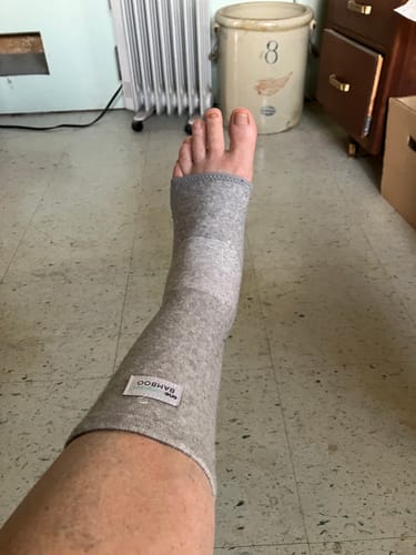 Customer wearing the grey Anti-Fatigue Bamboo Footsleeve on their foot and lower leg.