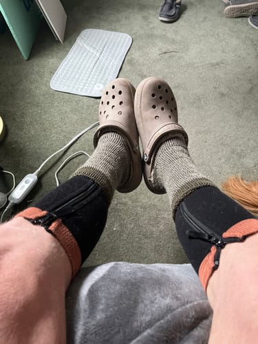 Reviewer's point-of-view wearing the black zippered Premium Anti-Fatigue Bamboo Footsleeves on both legs.