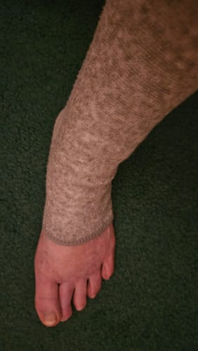 A customer's foot wearing the grey, open-toed Premium Anti-Fatigue Bamboo Footsleeve.