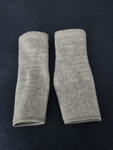 Reviewer's pair of gray Anti-Fatigue Bamboo Footsleeves laid flat on a dark surface.