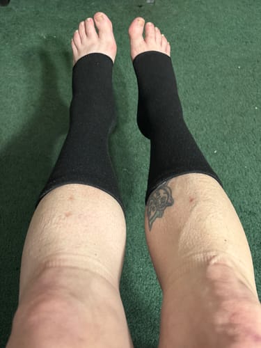 Customer's personal view of their feet wearing the black, open-toed bamboo footsleeves.
