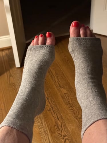 Customer wearing the grey open-toe Premium Anti-Fatigue Bamboo Footsleeves on both feet.