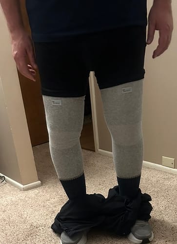 Reviewer wearing two grey Premium Bamboo Leg Sleeves, showing the full coverage from thigh to ankle.