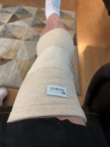 Close-up of a reviewer wearing the Premium Bamboo Knee Sleeve on their leg, seen from above.