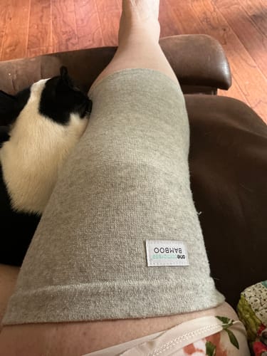Customer wearing the grey Premium Bamboo Knee Sleeve, showing its comfortable fit while relaxing.