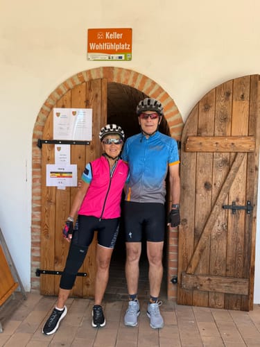 Reviewer wearing the black Premium Bamboo Knee Sleeve on her right leg while in cycling gear.