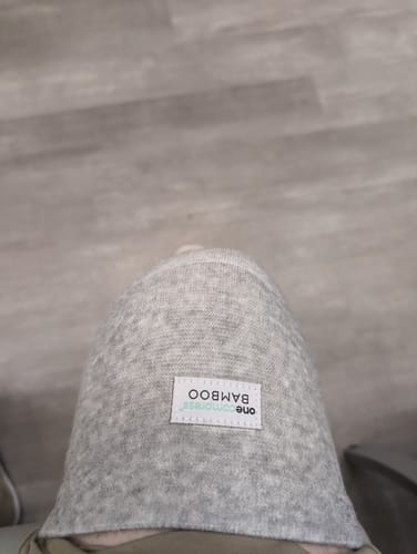 Reviewer's top-down view of the light grey Premium Bamboo Knee Sleeve being worn on their knee.