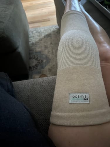 Customer wearing the comfortable Premium Bamboo Knee Sleeve on their leg while resting.