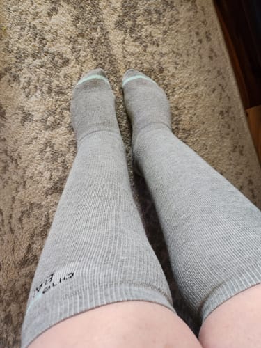Customer wearing the grey, knee-high Premium Bamboo Compression Socks.
