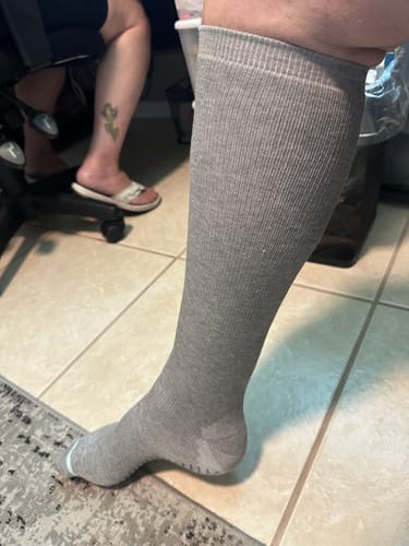 image 2 out of 2: Reviewer showing a side view of the grey Premium Bamboo Compression Socks on their leg.