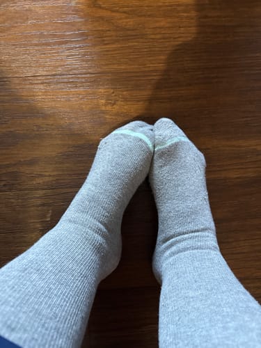Customer's point of view looking down at their feet in the gray Premium Bamboo Compression Socks.